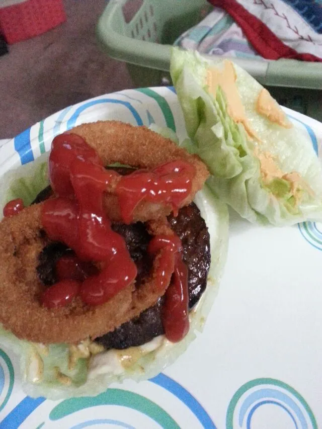 Snapdishの料理写真:burger with ketchup,  hummus,  onion,  mUstard,  onion rings, with a lettuce bun.|Polly Gelfusoさん