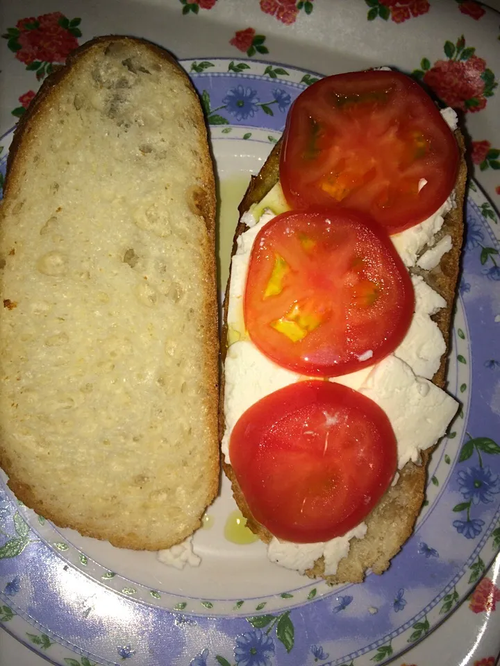 Feta cheese and tomato slices   With olive oil on baguette bread|aida arafatさん