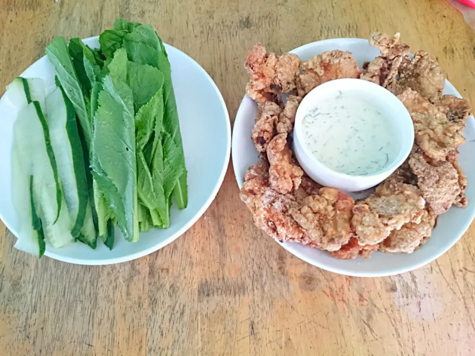 Snapdishの料理写真:fried chicken strips with sour cream and dill dip and a plate of sliced cucumber and mustard leaves|Junphil Dela Cruzさん