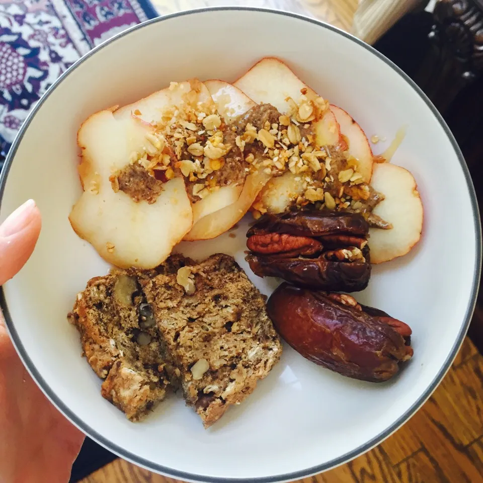 Pear with almond butter, granola and honey. 2 dates stuffed with pecans and homemade whole wheat banana nut bread. Glass of almond milk.|victoria valerioさん