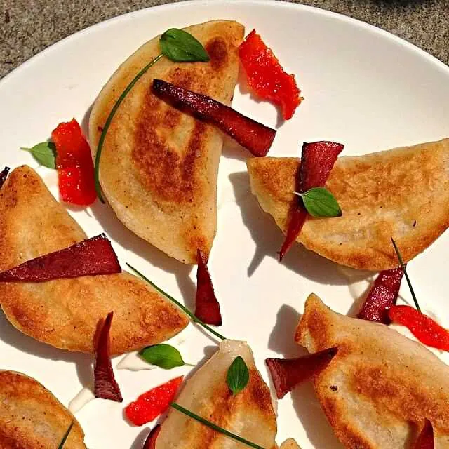 Onion and potato pierogies topped with Bologna tips and chive|CHUENCHAIさん