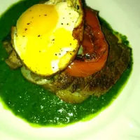 t-bone steak with sliced potatoes, olive salsa verde, beef steak tomato and fried egg|Erin Bizzieさん