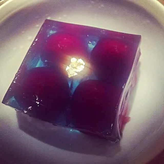 Snapdishの料理写真:de-pitted cherry stuffed with sweet macha tea encased in black jello garnished with gold leaf|CHUENCHAIさん