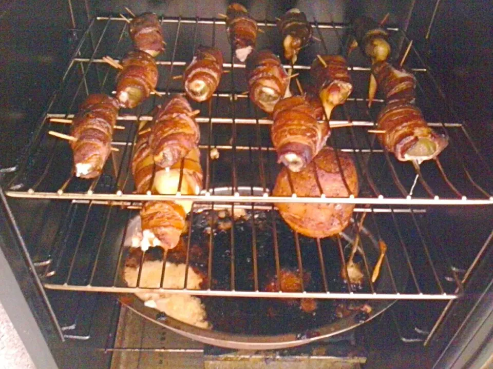 Snapdishの料理写真:Electric smoker filled with Atomic Bombs (bacon wrapped, cream cheese cheddar stuffed jalapeños)
with Cajun dry rubbed oinions|Mj Marijanneさん