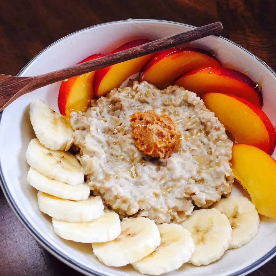 Snapdishの料理写真:Almond milk oatmeal with peanut butter, banana, and peaches topped with peanut butter and honey|victoria valerioさん