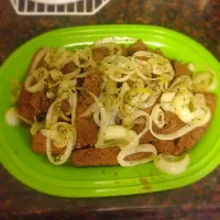 Marinated steak with sautéed onions. A little parsley to top it off|Brittany Fosterさん