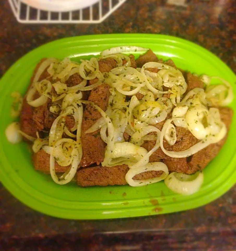 Marinated steak with sautéed onions. A little parsley to top it off|Brittany Fosterさん