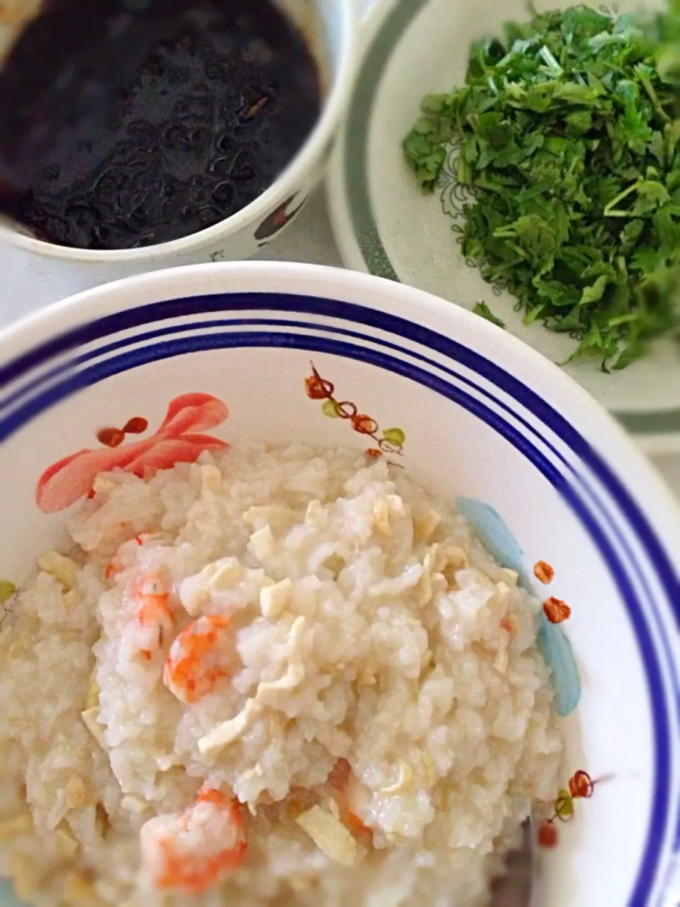 Prawn and tau kwa porridge with coriander garnish and shallot in dark sauce|karen limさん