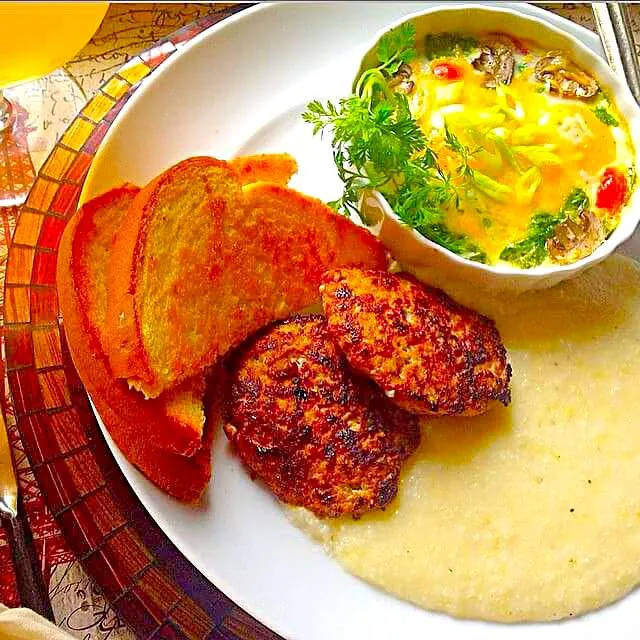 Snapdishの料理写真:Turkey pan sausage, creamy buttery grits, mushroom-tomato -herb soufflé and toast|CHUENCHAIさん