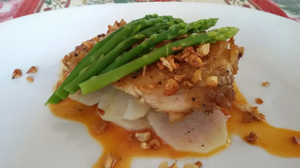 fried buttered garlic snapper. with some boiled potatoes and asparagus and with a tingy tomato sauce .|sherry rodriguesさん