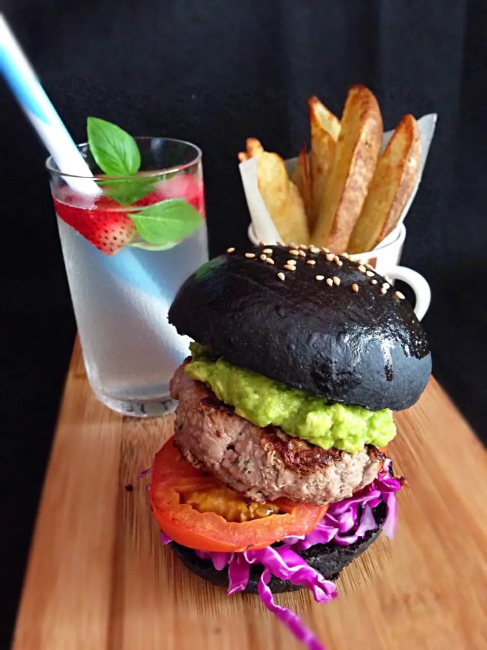 Beef burger on homemade squid ink bun with guacamole, baked spicy potato wedges, coconut water|coxiella24さん