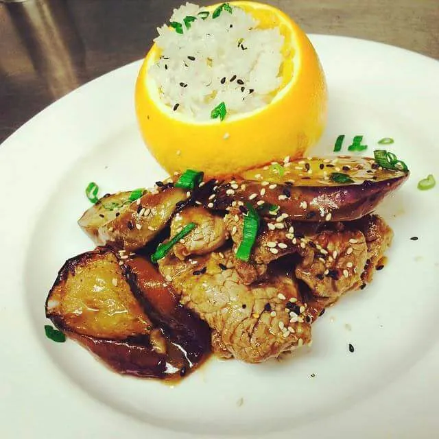 Snapdishの料理写真:Stir fried sesame ribeye and japanese eggplant with toasted sesame seeds and an orange soy glaze. Orange basmati rice.|CHUENCHAIさん