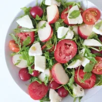 Red and white salad - donut peaches, grapes, tomatoes, mozzarella and arugula