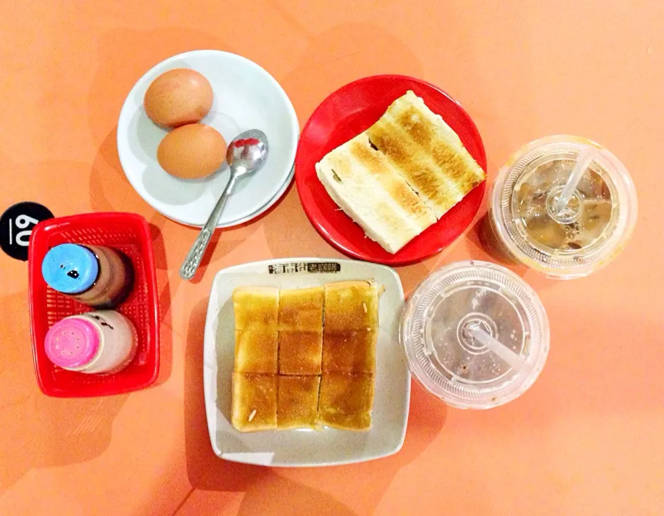 Snapdishの料理写真:Traditional Sg breakfast - kaya butter toast, kaya thick toast, soft boiled eggs, iced coffee and milo|coxiella24さん