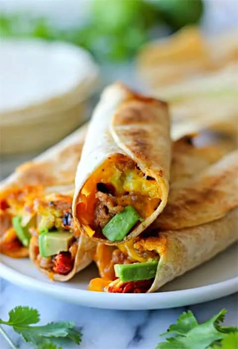 Sausage Egg W/ Red Chopped Chilli  Peppers Avacado  In A Toasted Cheese Wrap Tortilla  Shell|Sheila Harrisさん