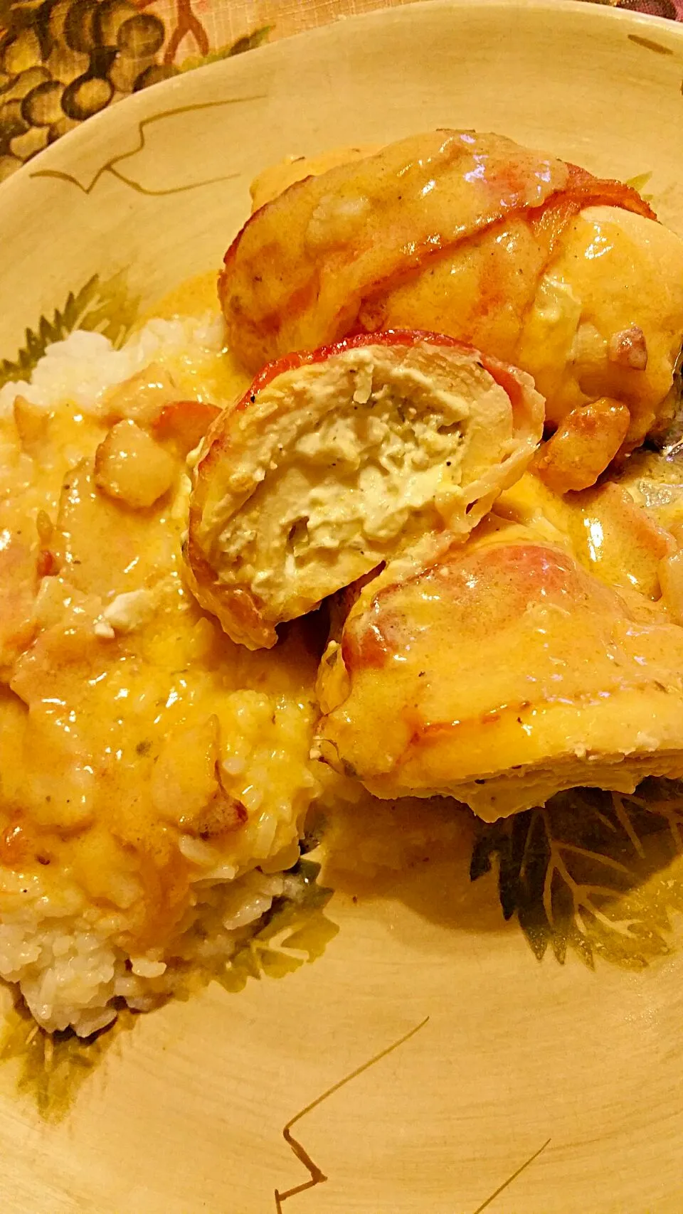 bacon wrapped cheese stuffed chicken breast with a sweet onion and bacon cream sauce served alongside rice|mさん