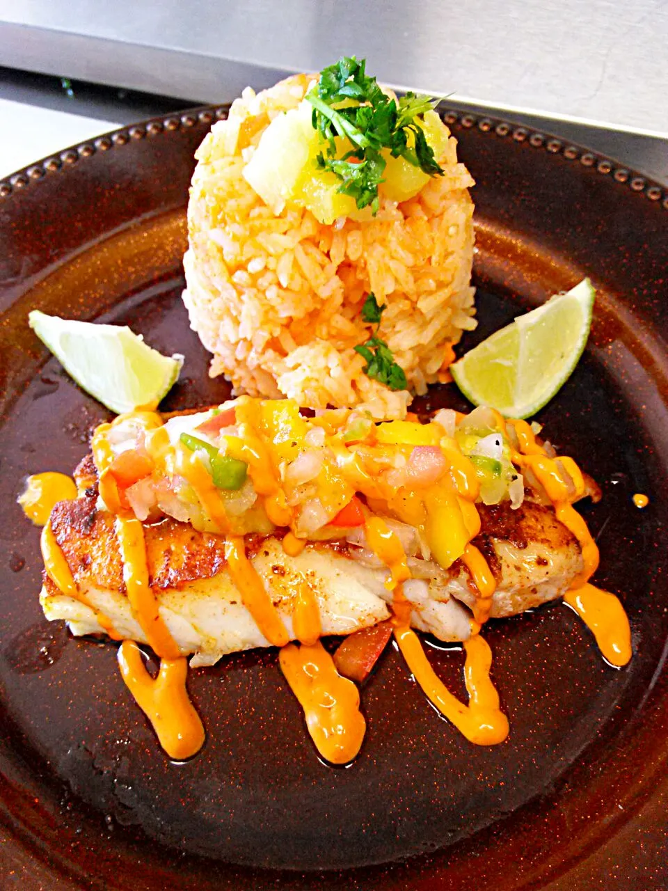 Grill fish with lemon rice, topped with pineapple, tropical and chipotle sauce.|Chef-Jonathan TRさん