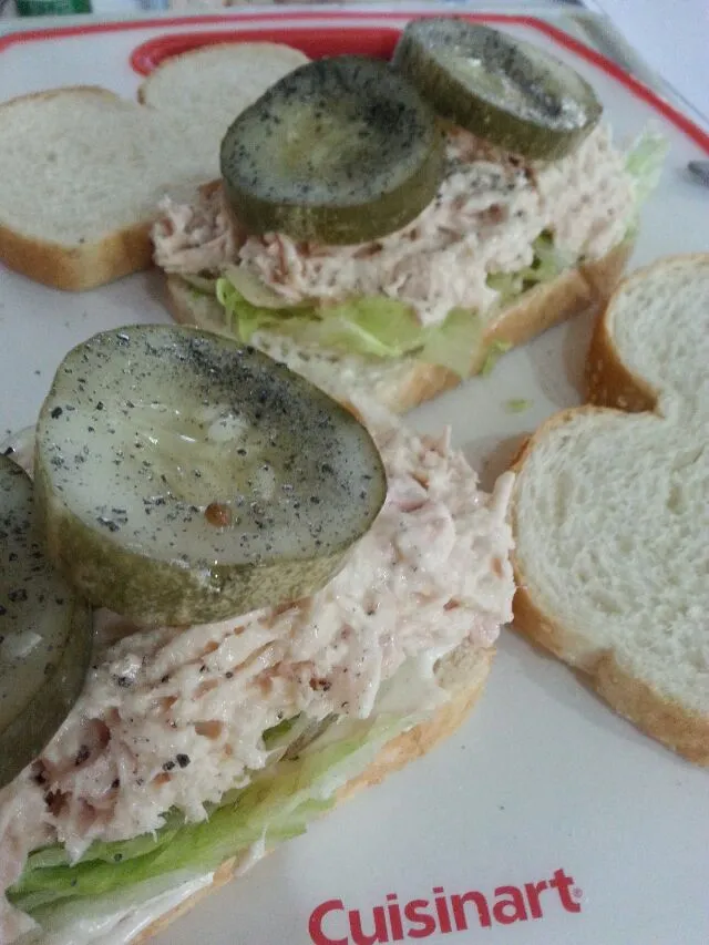 tuna salad sandwiches with lettuce and pickles.|Polly Gelfusoさん