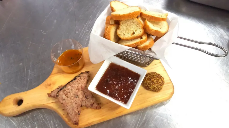 Rabbit rillette, sous vide in duck fat for 24 hours and topped with a cherry chutney, paired with country patê, whole grain mustard, mango chutney, and crostini|Jacki Carterさん