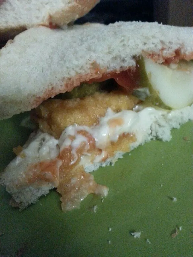 fish filet sandwich with pickle, ketchup, mayo.|Polly Gelfusoさん