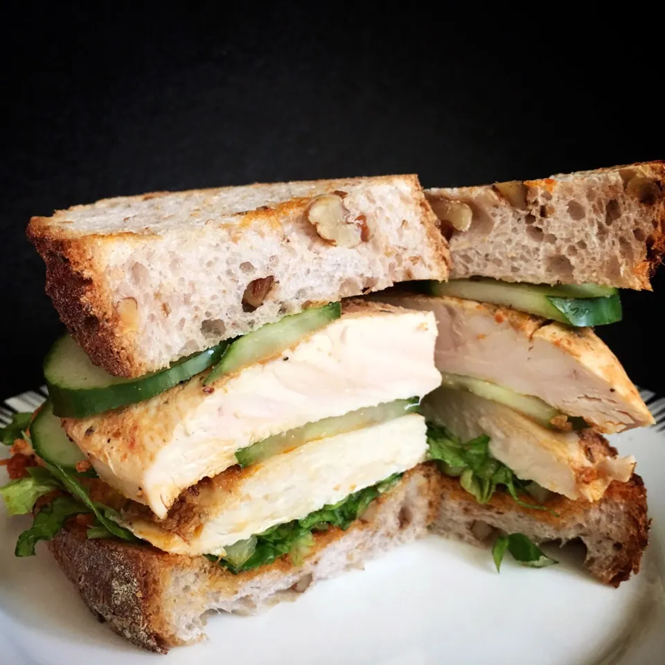 Sandwich of grilled chicken with sundried tomatoes pesto, lettuce & cucumber on wholemeal walnut bread|coxiella24さん