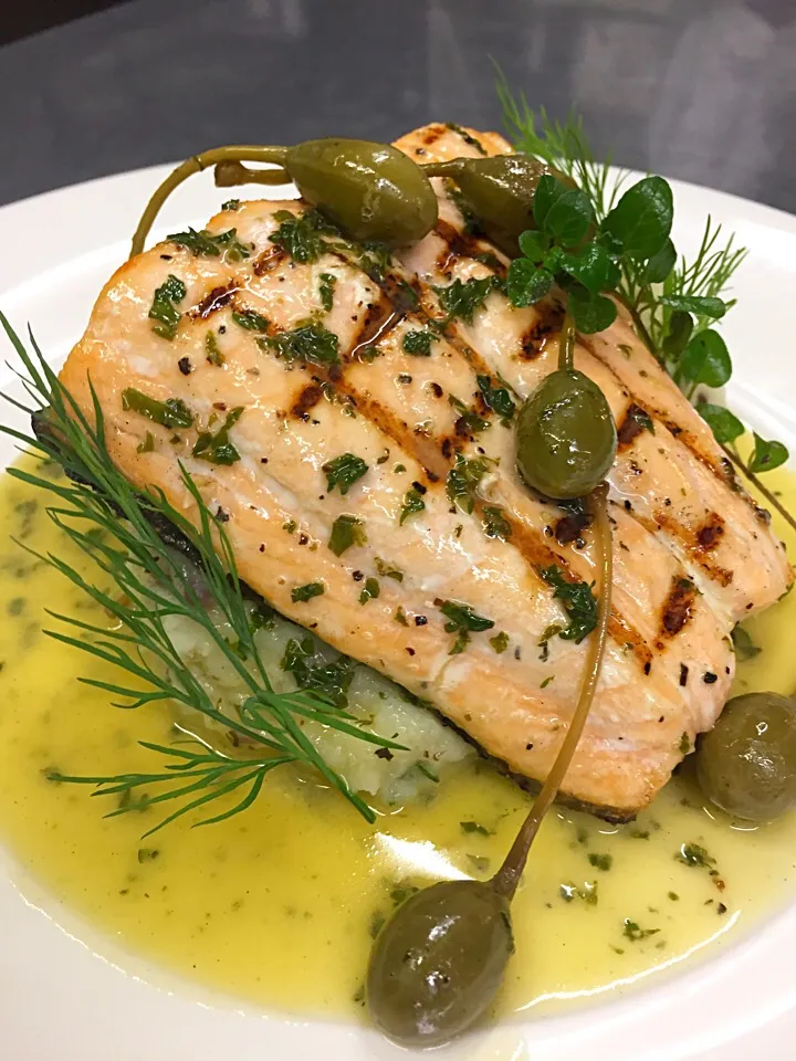 Grilled salmon with black olive mash, lemon caper butter|Michael Kohlさん