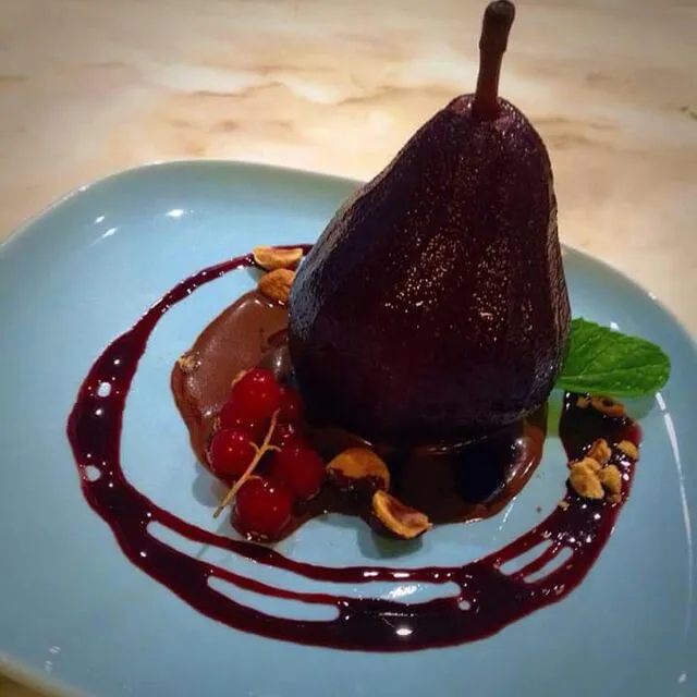 Sometimes all that needs to be done with a pear is drenching it in sweet red wine and some warm autumn spices. We served up this one in a pool of chocolate sauc|CHUENCHAIさん