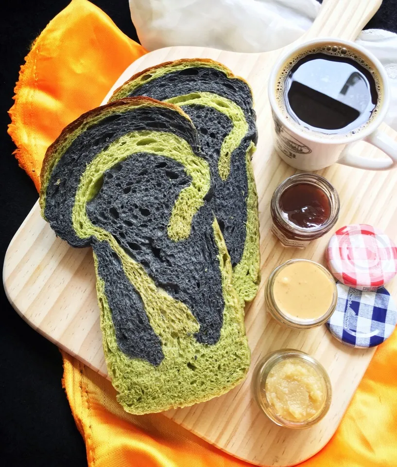 Snapdishの料理写真:Matcha & bamboo charcoal swirl bread with raspberry jam, peanut butter & kaya(coconut jam). ☕️。|coxiella24さん