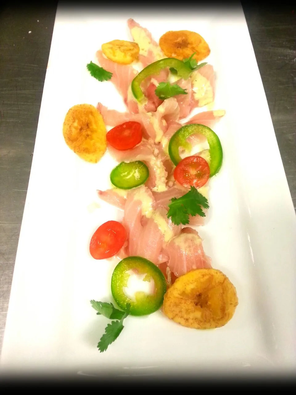 Hamachi Crudo with crisp plantains, jalapenos, lime and yuzu|Jarrod Seamanさん