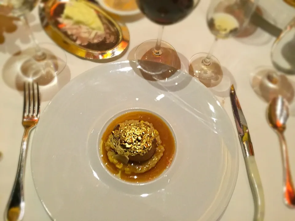 Snapdishの料理写真:23 karat gold covering Quail stuffed with foie gras and black truffle sitting on a bed of truffle risotto|robert flickerさん