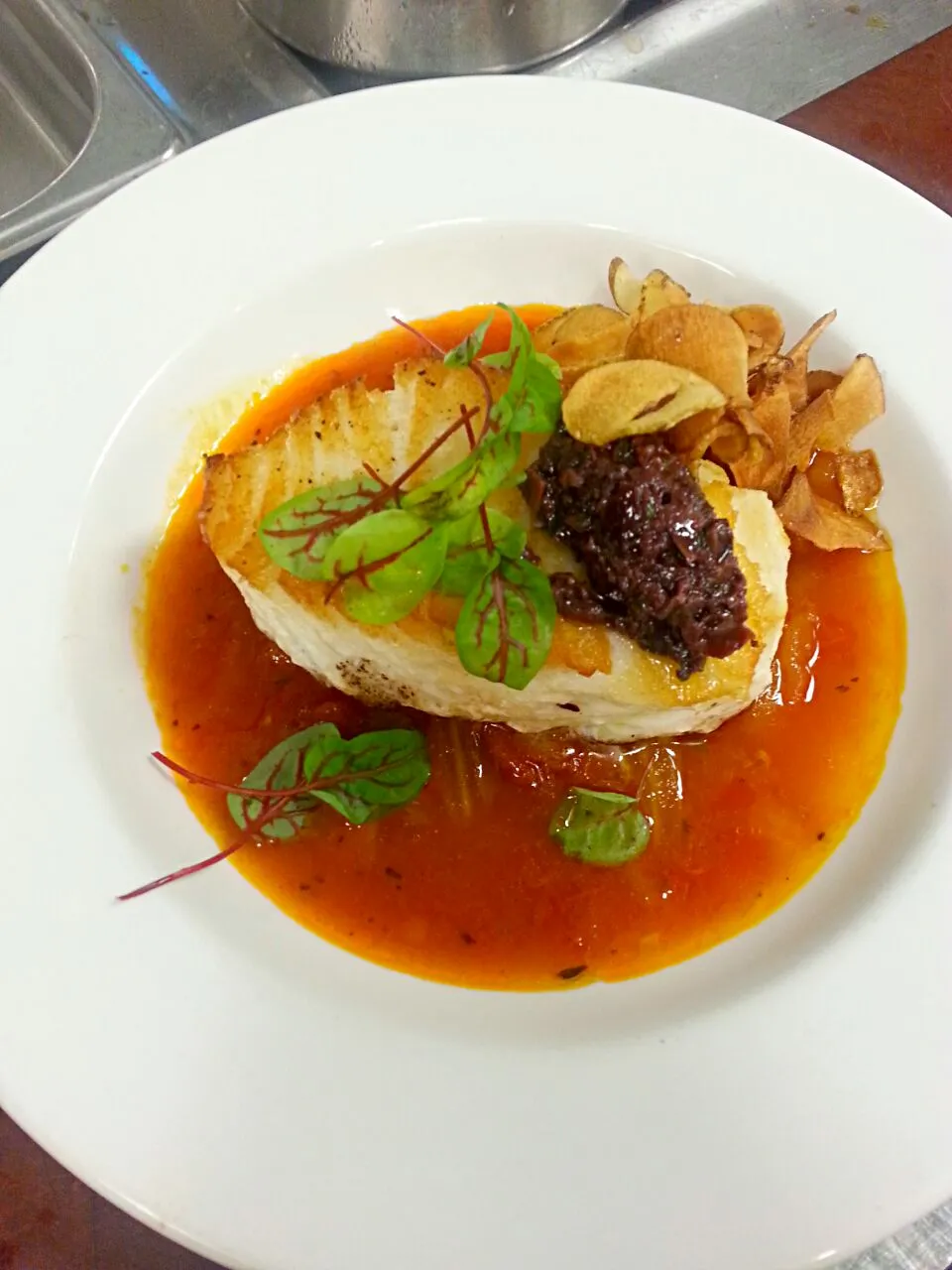 Pan seared Chilean sea bass with fennel tomato broth, Olive tapenade and crisp sun chokes|Jarrod Seamanさん