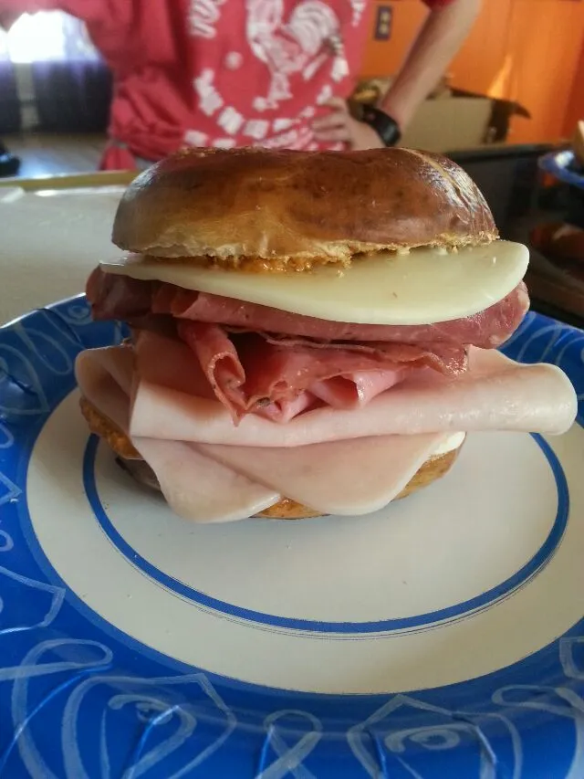 My daughter's pretzel bagel sandwich after school.  with mustard, mayo,prov, ham, pastrami, & turkey.|Polly Gelfusoさん