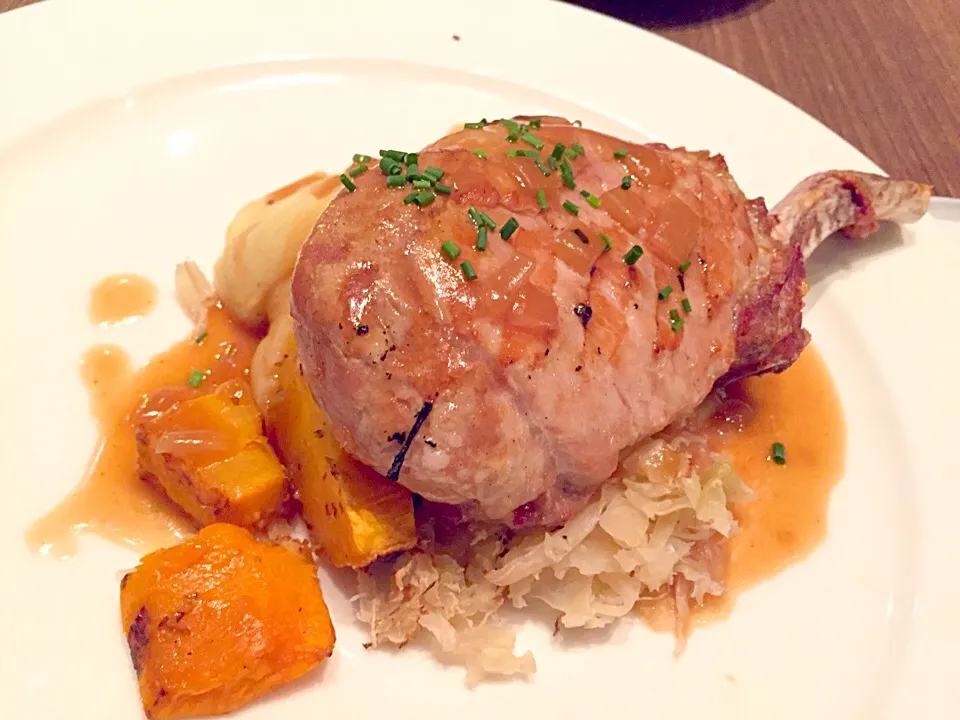 Pork loin chop served with bacon sauerkraut, grilled pumpkin, mustard & onion mash, & apple cider gravy|Sky Blueさん