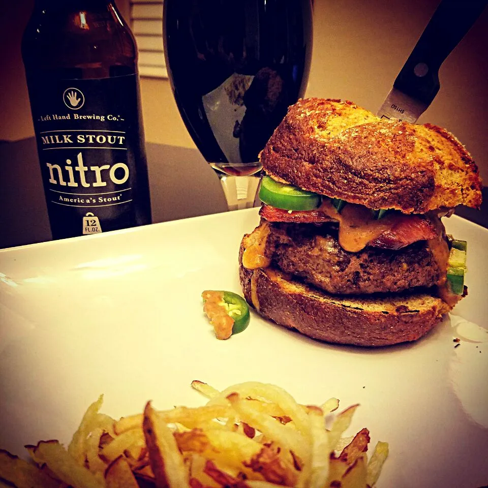 Snapdishの料理写真:Wisconsin Tavern Burger stuffed w/ Real Wisconsin Sharp Cheddar Cheese & Red Jalepeno Chips, topped w/ Bacon & Fresh Jalepenos, smothered w/ Nitro Milk Stout Be|Chef Cam Wolfeさん