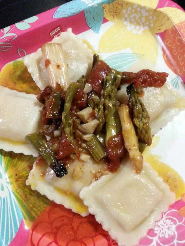 Snapdishの料理写真:vegan ravioli topped with green and white asparagus,  tomato and tons of garlic in a butter, lemon, and mirin sauce.|Polly Gelfusoさん