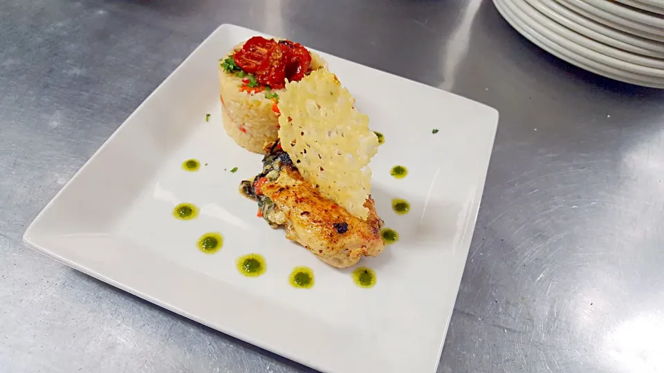 chicken florentine riladin with parmesan crips basil pesto toasted walnut oil oven dried cherry tomatoes and roasted red pepper fennel rice|Jayson Mccrimmonさん