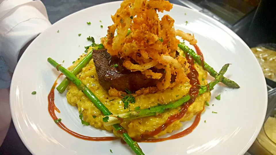 smoked brisket over saffron risotto with a bbq demi  sauce and grilled asparagus|chef Charlesさん