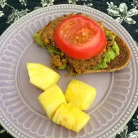 Open faced veggie burger with guacamole and tomato. Side of pineapple. (Half way eaten!)|sarah rose chaconさん