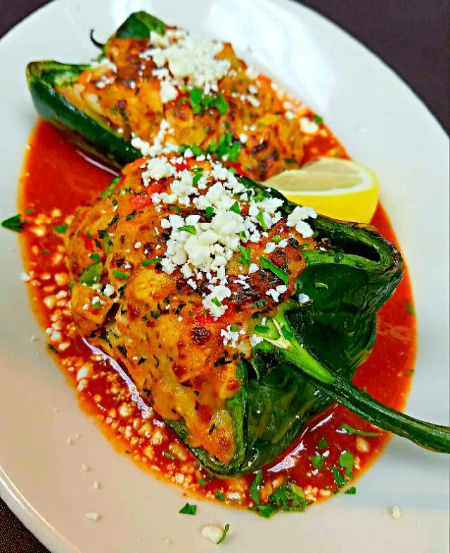 chicken picadillo stuffed poblano peppers,served over a smoked red pepper coulis...finished with cotija cheese|chef Charlesさん