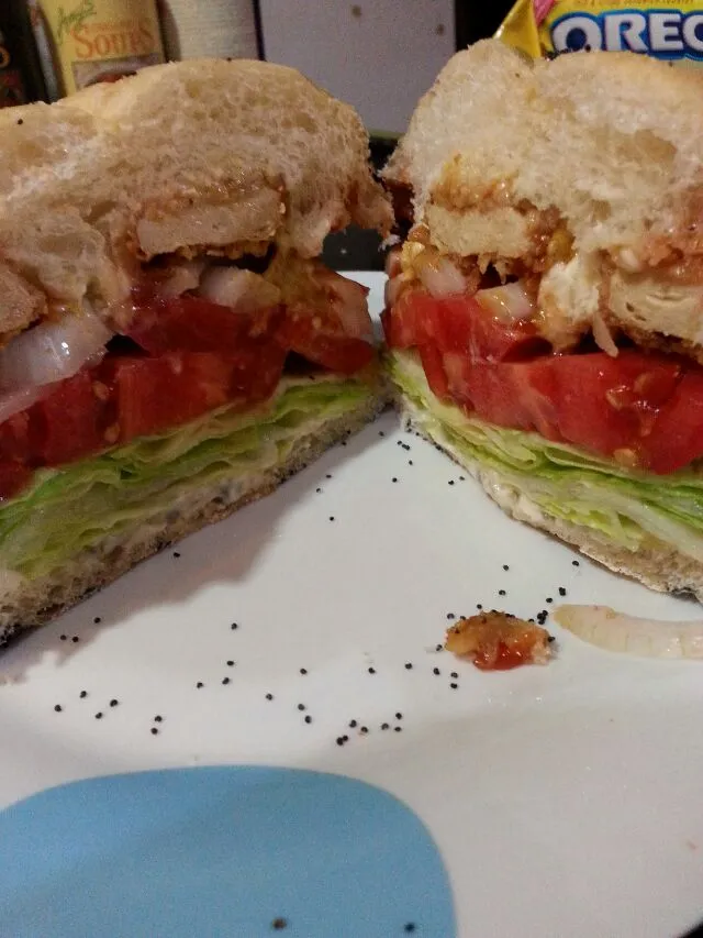 gardein chix tender burger with the works on a poppy seed roll.|Polly Gelfusoさん