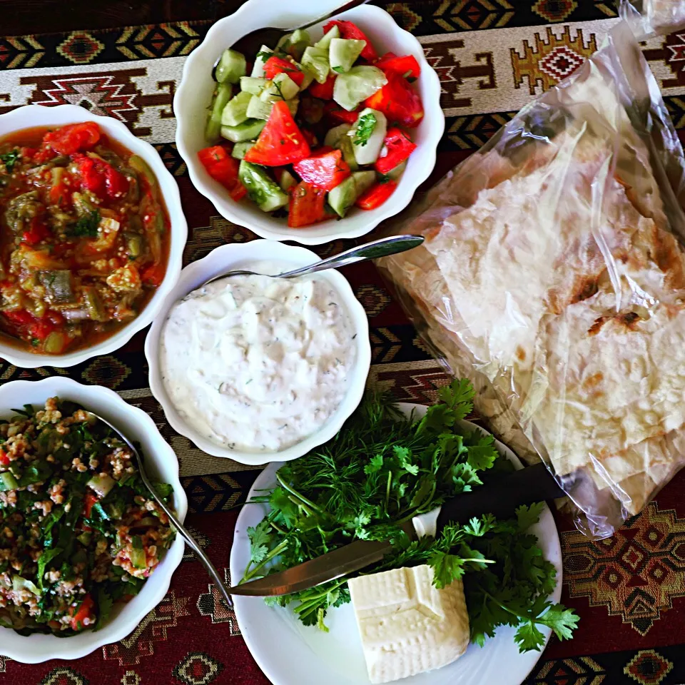 Snapdishの料理写真:Delicious Armenian food. Great destination for #Vegetarians.  Here we have: Lavash bred with cheese and herbs. Tomato, cucumber salad with Thai basil. Yogurt wi|Amandaさん