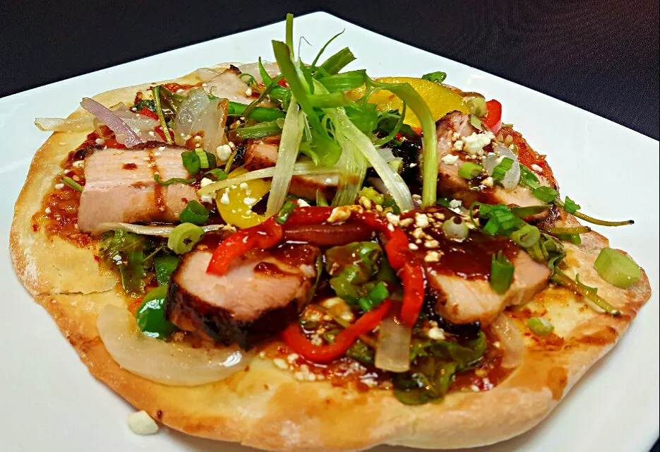 Brulee'd pork belly pizza,with sweet chili sauce,grilled peppers and onions,arugula,cotija cheese and finished with a miso bbq|chef Charlesさん