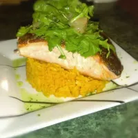 Pan seared salmon with yellow rice topped with a citrus salad.|Derek Ortizさん