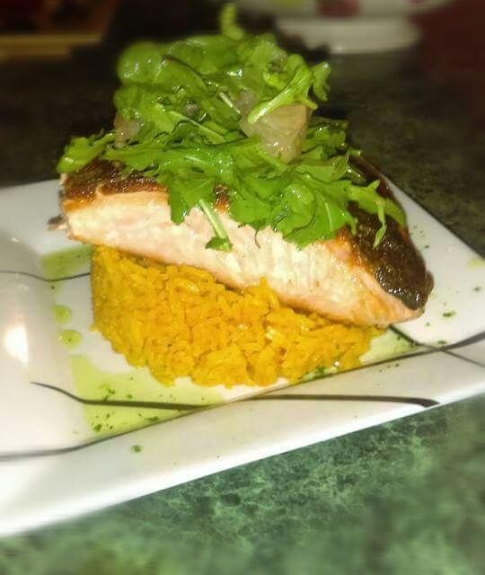 Pan seared salmon with yellow rice topped with a citrus salad/Derek