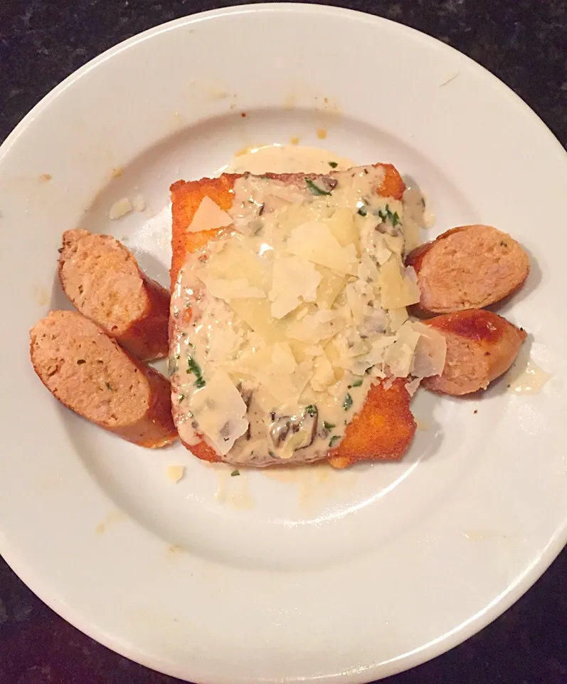 Fried polenta with porcini cream sauce, shaved Parmesan and chicken sausage.|ernest ristiさん