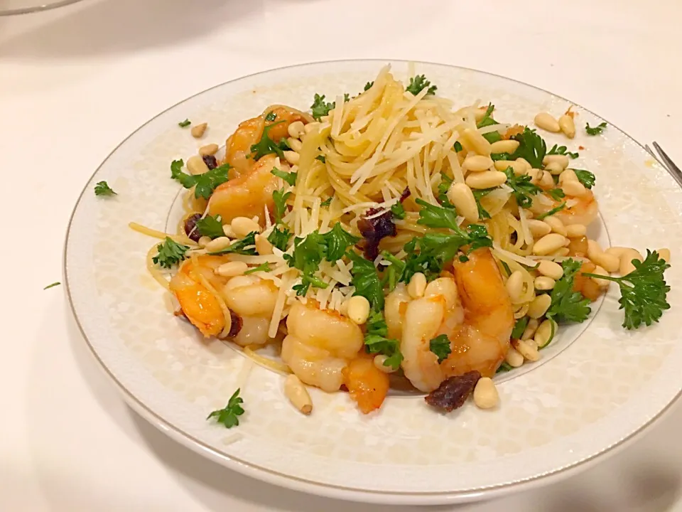 Snapdishの料理写真:Angel hair pasta with sautéed prochuto shrimp sun dried tomatoes topped with pine nuts shredded Parmesan cheese and parsley.|Garthoneさん