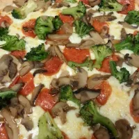 pepperoni mushroom and broccoli pizza