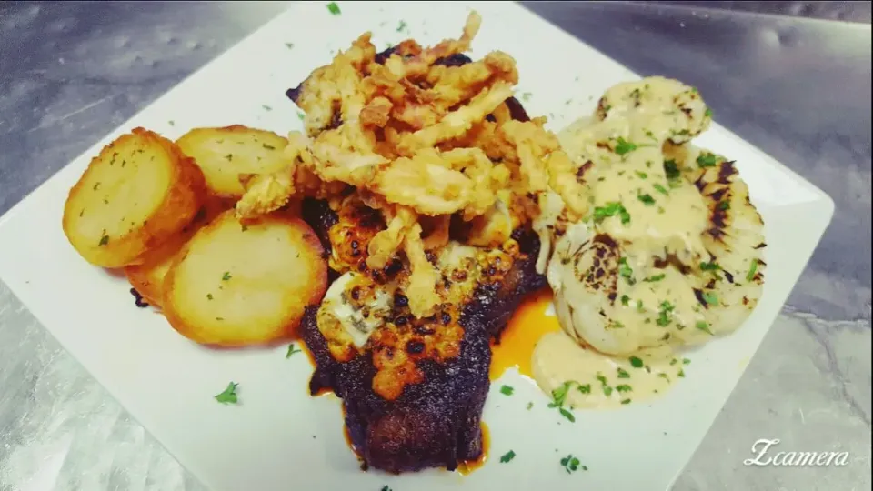 14 oz ribeye,blackened and topped with gorgonzola cheese...served with grilled cauliflower and fried potatoes..|chef Charlesさん