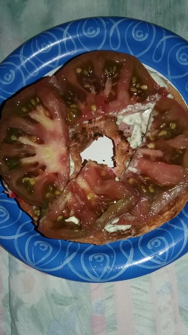 my birthday breakfast.  Berry bagel with butter,  pesto mayo,  and heirloom tomatoes.|Polly Gelfusoさん