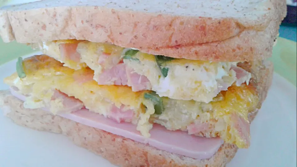 Snapdishの料理写真:Breakfadt sandwich. 
Baked eggs with ham, cheese, onion, bell peppers, mayonnaise, mustard and ranchera mexucan sauce.|Jorge Bernal Márquezさん